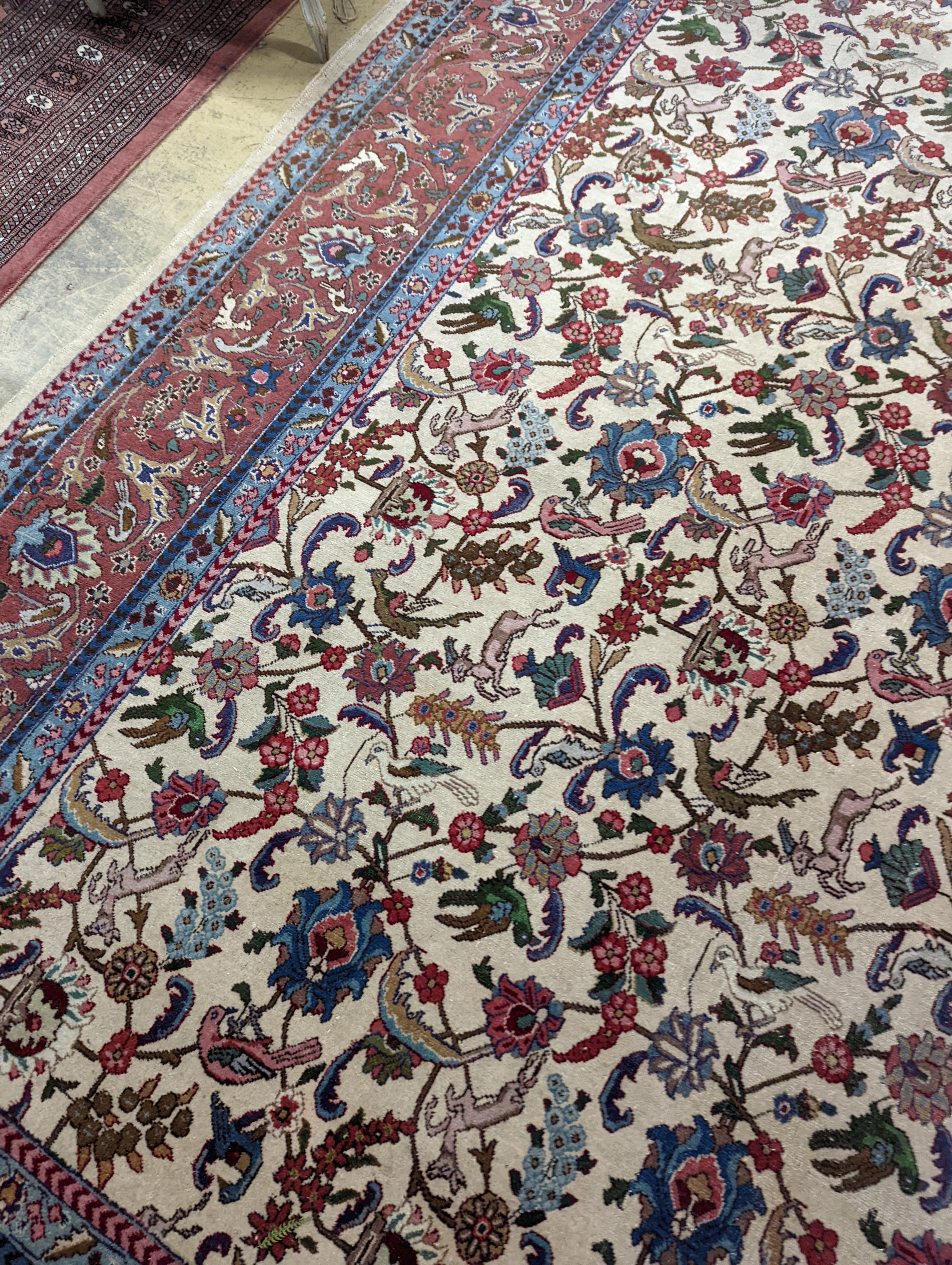 An Ispahan ivory ground carpet woven with flowers and animals, 386 x 276cm